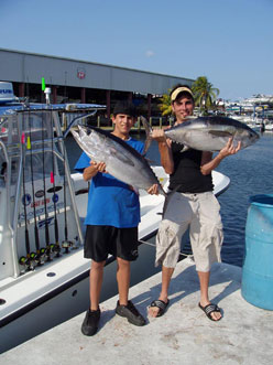 Father and son with a pair of blackfin tunas