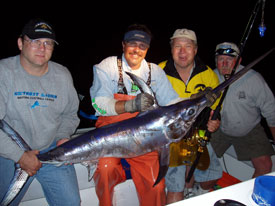 Four clients posing with their swordfish